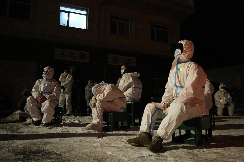 2021年1月25日午夜，吉林通化，防疫人员在短暂休息。他们坚守岗位，或为隔离居民运送生活物资，或对进出城车辆进行消杀。&nbsp;苍雁/中新社 图